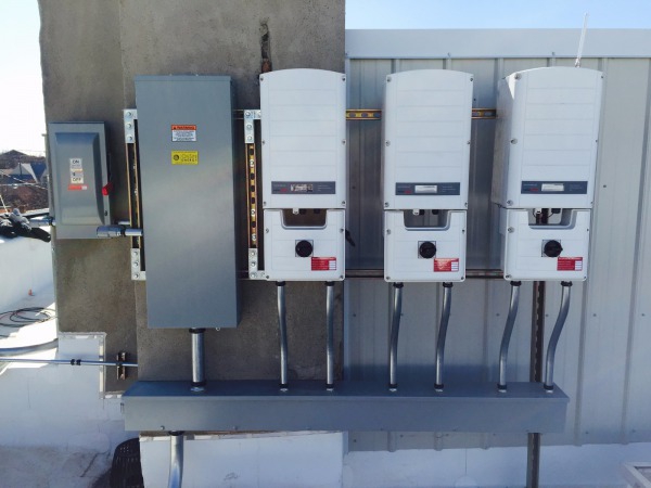 SolarEdge inverters convert the DC power from the solar array into usable AC power for the building's electrical loads.