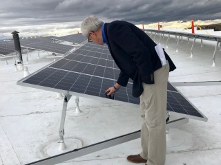 Lt. Governor Mike Cooney makes sure the array is sturdy  