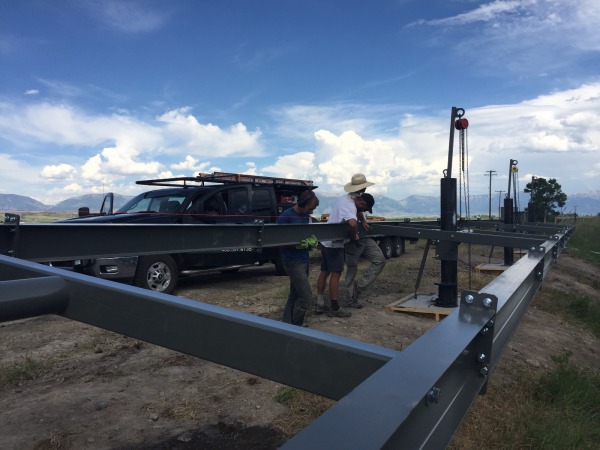 Crew members assembling the steel I-Beam structure.  Building the array at waist level before hoisting is the way to go!